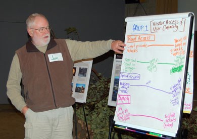 Participant at Feb. 10 public workshop presents possible planning sideboards as part of group exercise.
