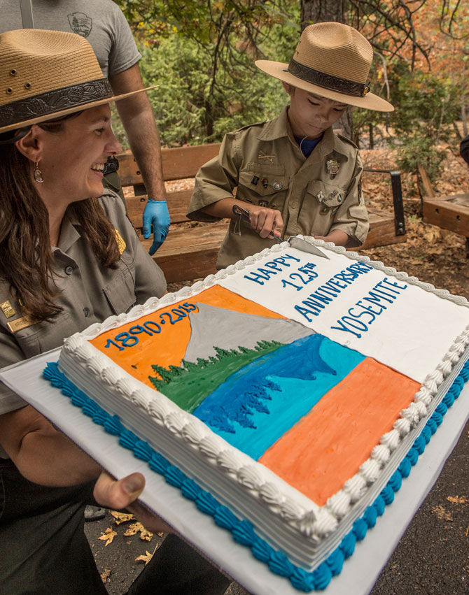Gabriel Lavan-Ying, better known as "Ranger Gabriel," cuts a commemorative anniversary cake at the conclusion of Yosemite National Park's 125th Anniversary celebration.