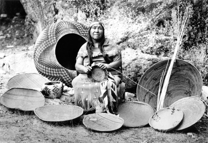 Indian woman surrounded by baskets