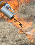 Drip torch setting fire to a field
