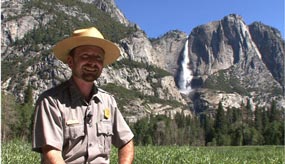 Ranger sitting in front of Yosemite Falls