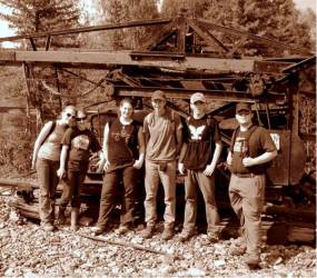 ASRA archaeology students standing in front of historic mining equipment