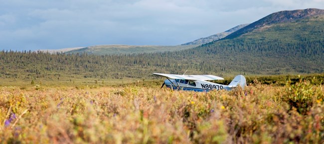 Bush plane parked in a mountain valley
