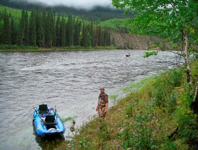 A hunter, raft, and caribou on the Charley River