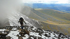 A hiker on a mountain in the preserve