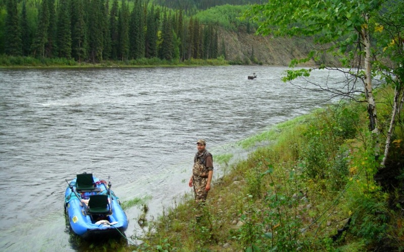 A hunter, raft, and caribou on the Charley River