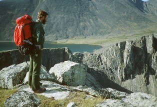 A hiker enjoys the view at Cirque Lakes