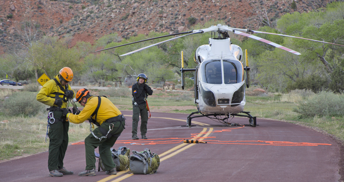 The SAR team preforms a safety check before hooking up to the helicopter.
