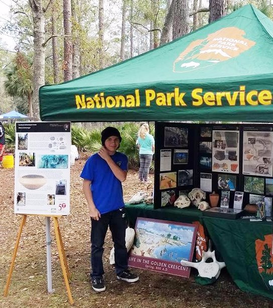 A college student VIP assisting with an outreach event