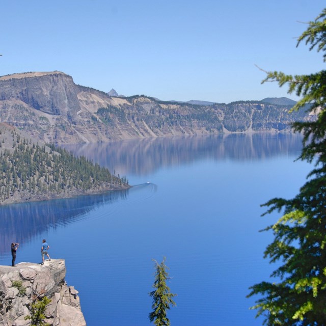 Mountain lake reflecting blue sky