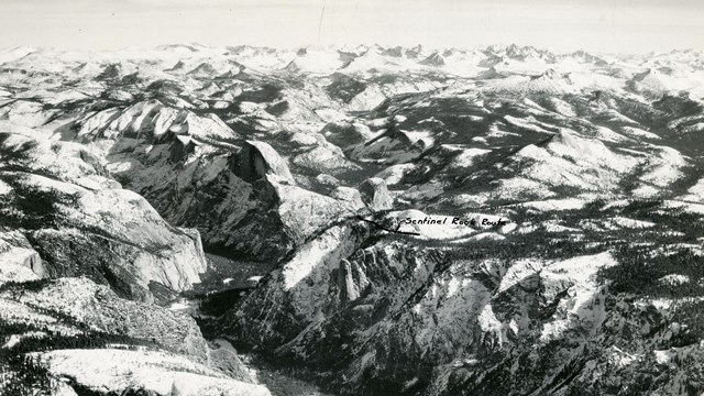 black and white of snow capped mountains extending for miles