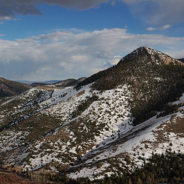 Mountain ridge partly covered in snow