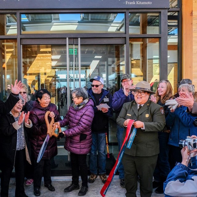 Group cutting a ribbon at a ribbon cutting ceremony