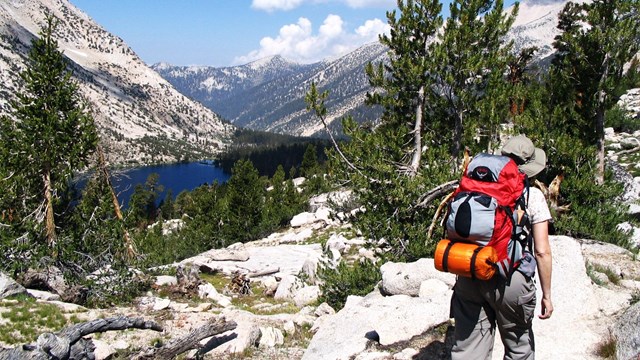 A hiker near an alpine lake