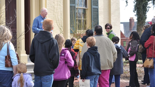 A VIP assists staff during a tour