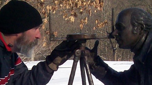 Hiker and statue of Albert Gallatin