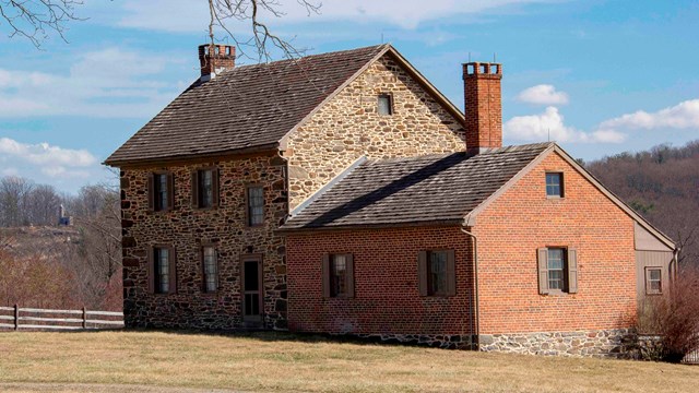 A photo of the Bushman House with Little Round Top in the background.