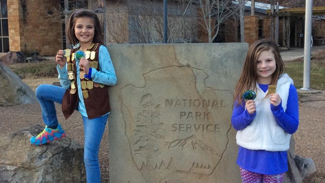 two girls with Junior Ranger badges