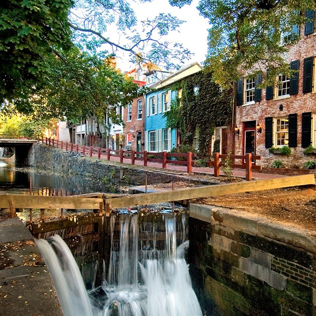 a canal lock on left, brick houses on right