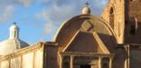 Sunlight illuminates the top of historic Mission San José de Tumacácori church.