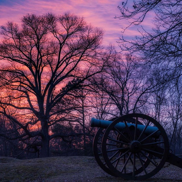 Canon on historic battlefield at sunset