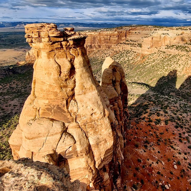 red orange canyon cliffs with a dry streambed below