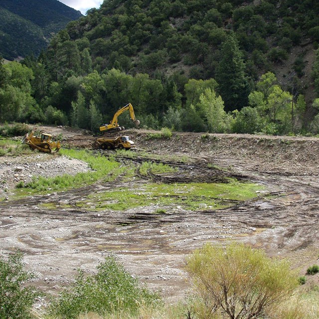 heavy equipment restoring a gravel borrow site