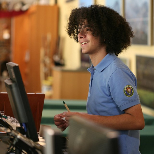 Volunteer at a visitor center desk 