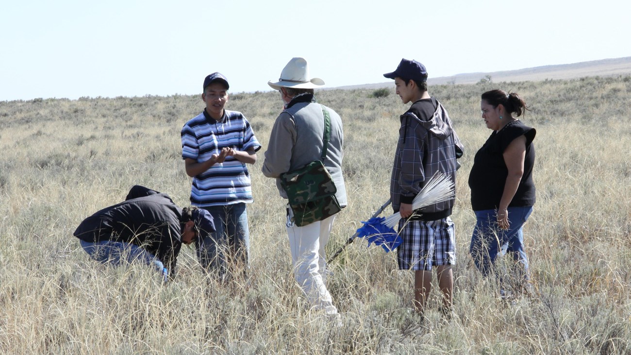 Tribal members share information on the prairie.