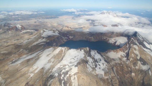 photo of a mountain top crater lake