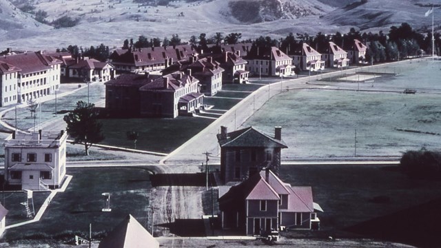 Historic photograph of Fort Yellowstone showing the red-roofed buildings of Officer's Row.