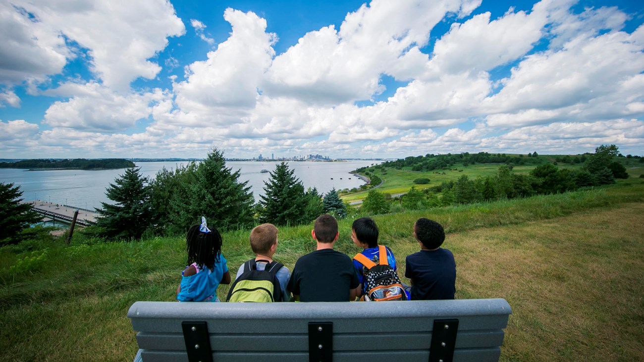 Children looking back at the city from the Boston Harbor Islands