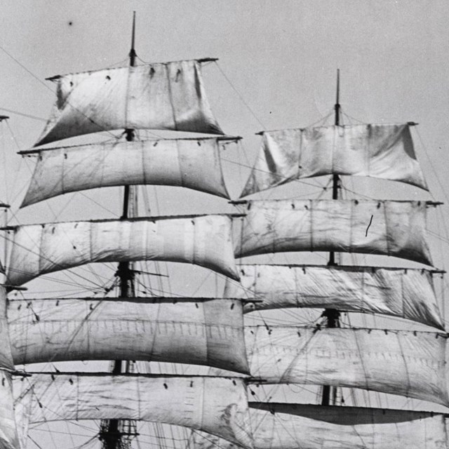 B&W photo of ships mast with sails