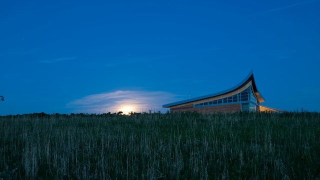 Sun rising in the east over the Homestead NHP's Heritage Center.