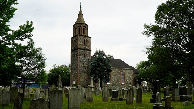 St. Paul's Church and cemetery against a stormy background.