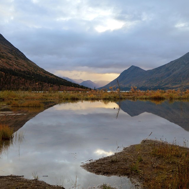 a mountain range is reflected in a lake