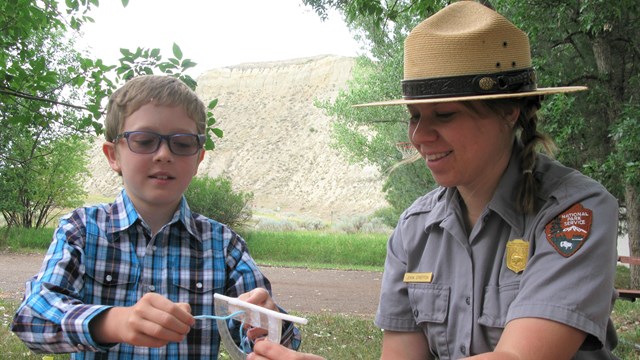 Ranger with child at table.