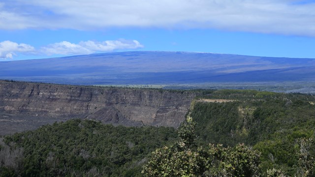 photo of a broad low volcanic mountain in the distance