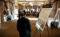 a man walks by a planning meeting agenda sign as he enters room