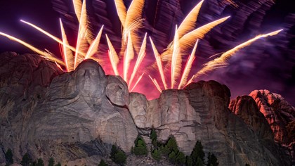 Fireworks display over the faces on Mount Rushmore at night.