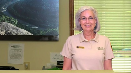 volunteer behind a visitor center desk