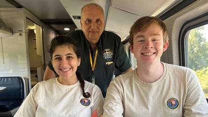 Trails & Rails volunteers smiling onboard an Amtrak train 