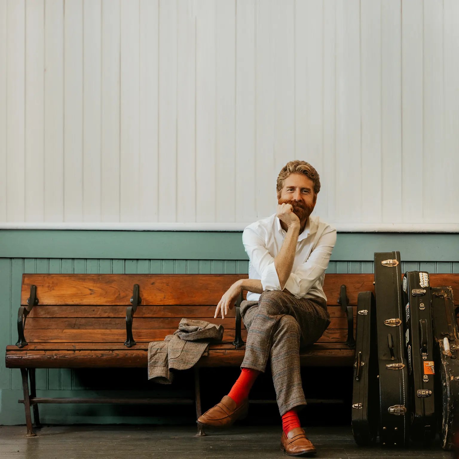 A color photo showing a man with red beard sitting on a courch