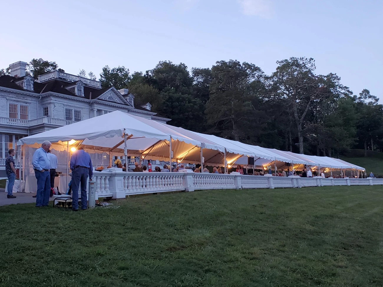 DenimBall Large event tent in front of a historic building at night