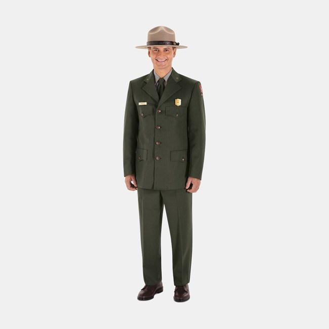 An NPS employee wearing a ranger hat, green dress coat and pants, and brown shoes