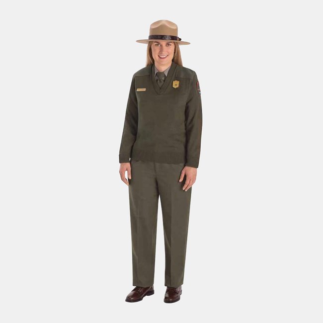 Winter Service Uniform An NPS employee wearing a felt ranger hat, green tie, sweater, and pants, and brown shoes