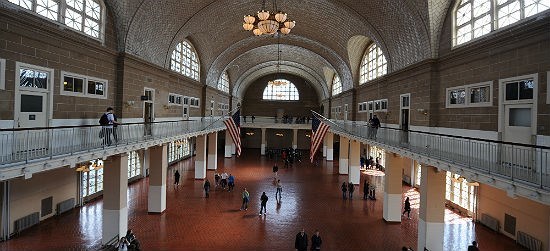 Great Hall at Ellis Island Immigration Museum large two-story hall with vaulted ceilings and elevated railed walkway