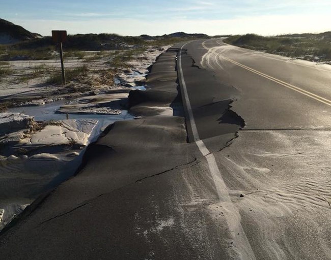 an asphalt road with crumbling edges