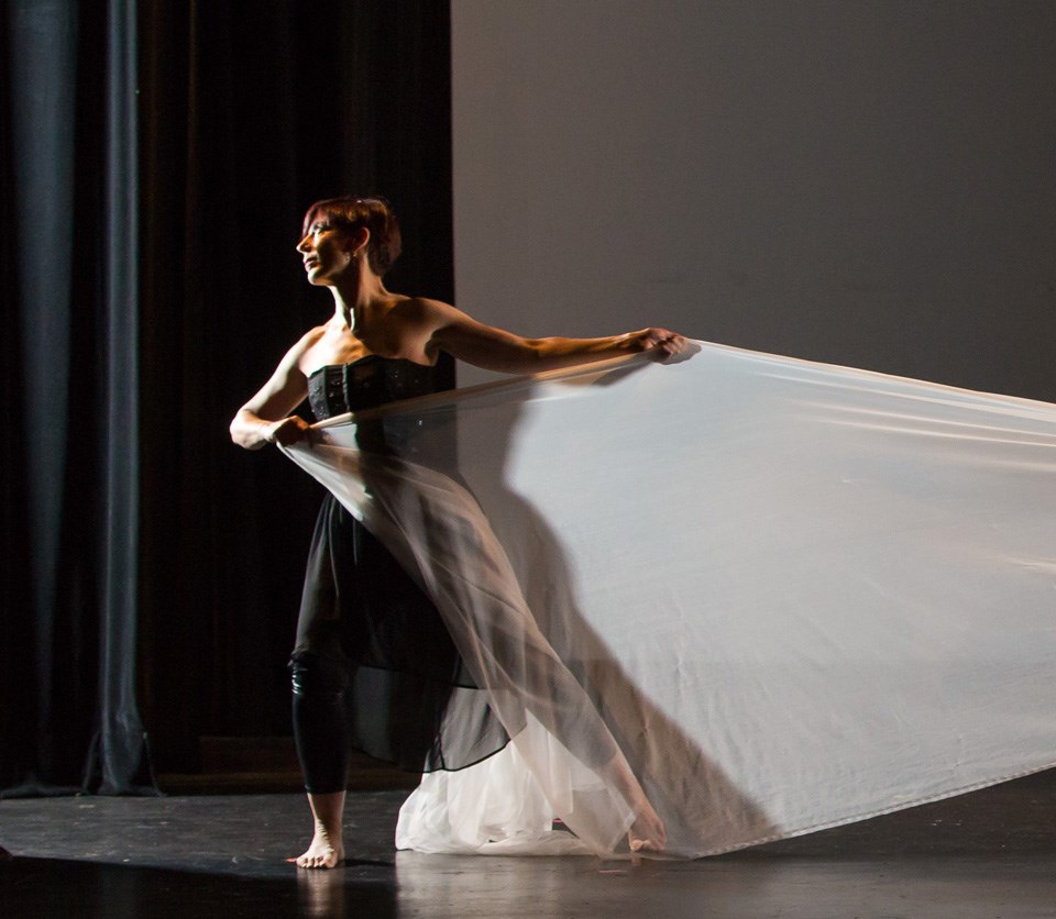 Dancer on stage in dramatic lighting