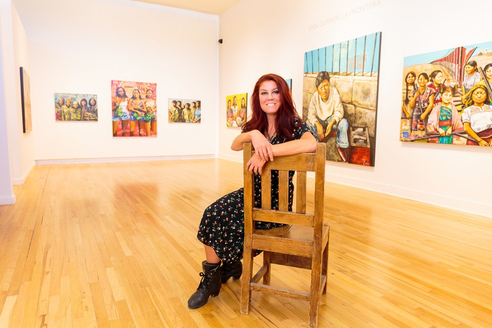 Woman sitting on wooden chair in art gallery